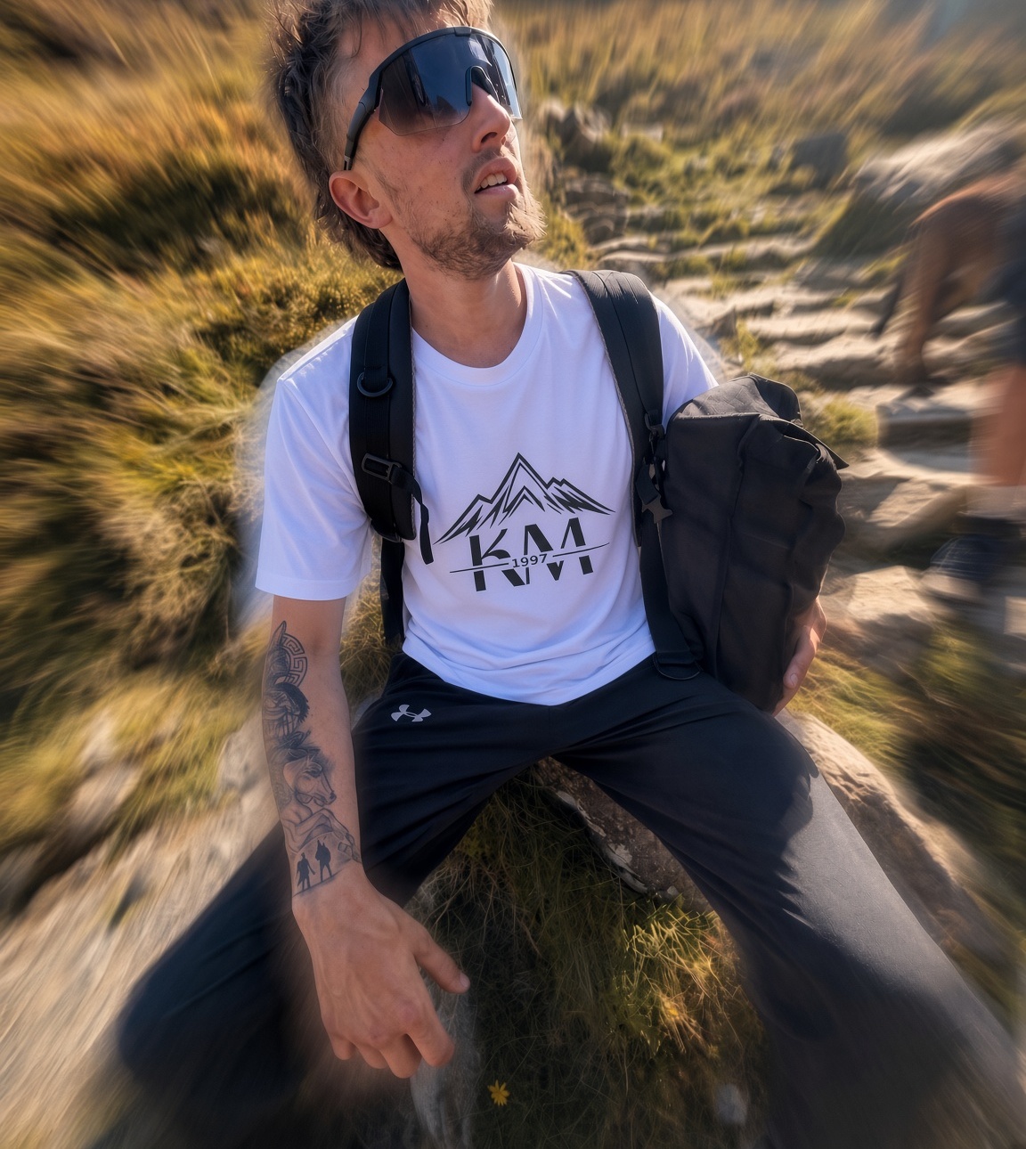 Hiker in a KM1997 tee on a mountain path