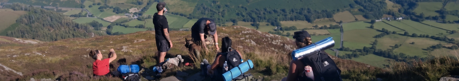 Group of hikers walking a rocky mountain trail with full packs